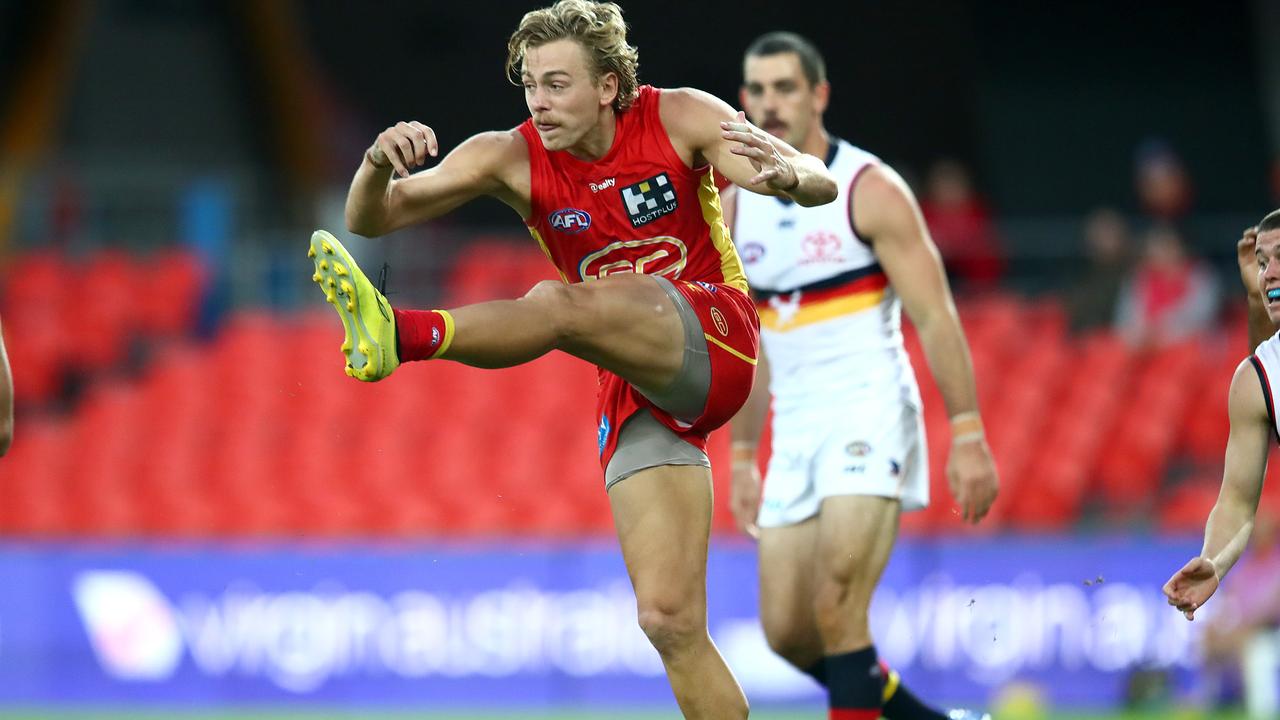 GOLD COAST, AUSTRALIA - JUNE 21: Hugh Greenwood of the Suns kicks the ball during the round 3 AFL match between the Gold Coast Suns and the Adelaide Crows at Metricon Stadium on June 21, 2020 in Gold Coast, Australia. (Photo by Jono Searle/AFL Photos/via Getty Images )
