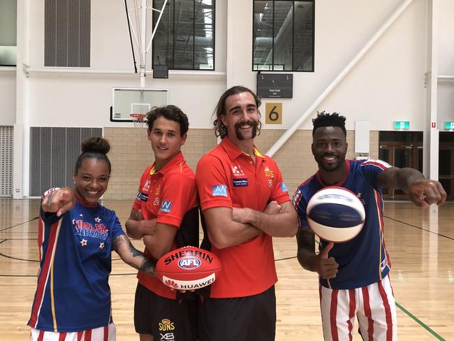 Gold Coast Suns players Wil Powell (middle, left) and Brayden Crossley (middle, right) with players from the Harlem Globetrotters. Picture credit: Supplied by the Suns.