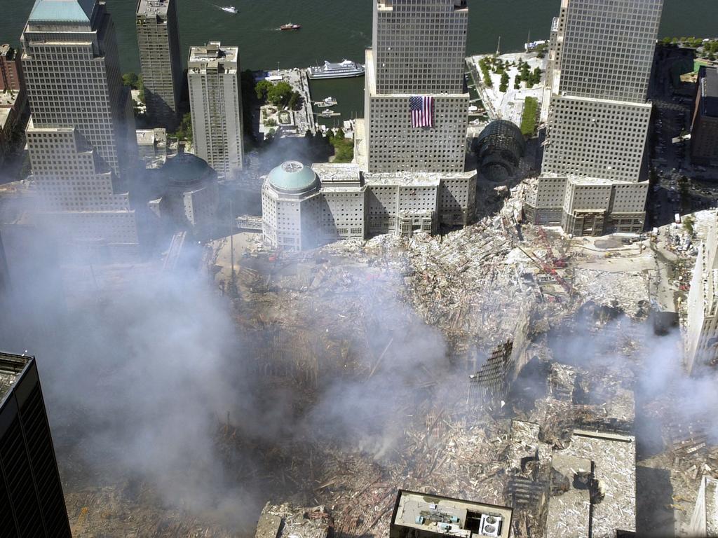 An aerial view of the destruction by terrorists of the World Trade Centre on September 15, 2001 in New York City. The view is to the west, with an American flag draped on one of the World Financial Centre towers. Picture: Alamy