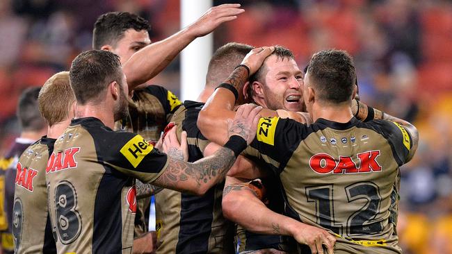 Trent Merrin’s team mates congratulate him after scoring a try during the round 20 match. Picture: Bradley Kanaris/Getty Images