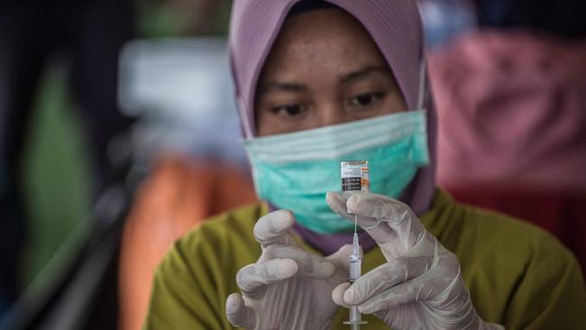 A health worker prepares a syringe of the Sinovac Covid-19 coronavirus vaccine in Surabaya, Indonesia. Picture: AFP