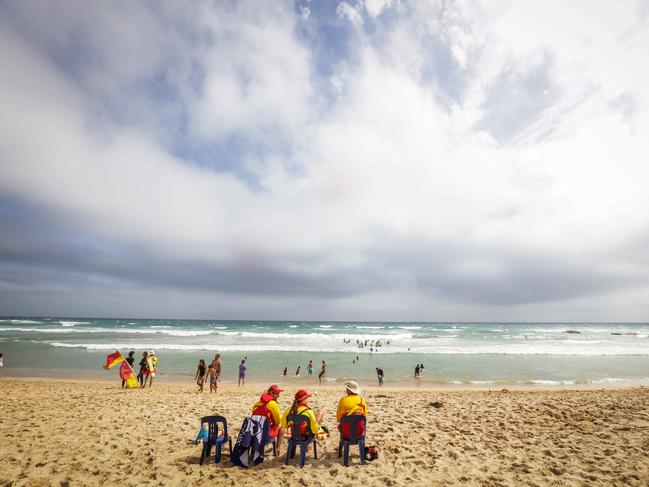 Life savers watch over swimmers at Portsea Surf Beach as the cool change arrives. Picture: Nicole Cleary