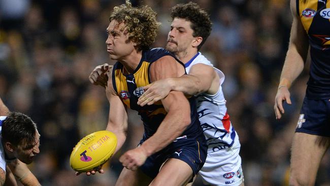 Tom Liberatore tries to wrap up Matthew Priddis. Picture: Daniel Wilkins