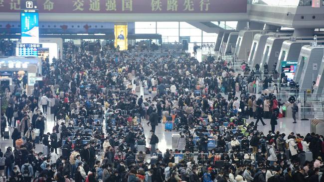 People wait to board trains at Hangzhou, as people begin to head for their hometowns ahead of the Lunar New Year. (Picture: AFP