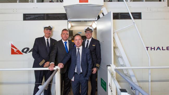 Qantas CEO Alan Joyce with NSW Government minister Anthony Roberts and pilots at the flight simulator training centre in 2016.