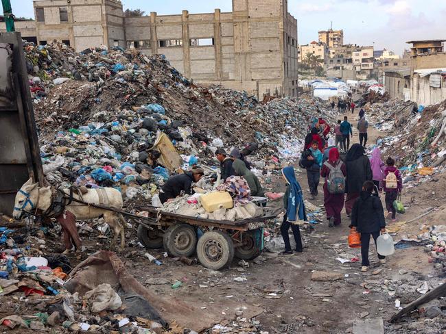 Displaced Palestinians search for salvageable items at a landfill near their camp in the Yarmuk area in Gaza City. Picture: AFP