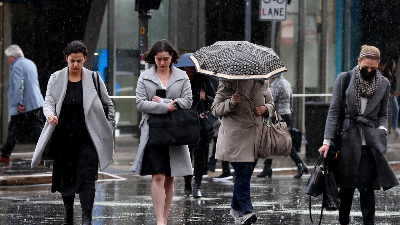 Adelaide pedestrians try to keep dry as Adelaide is hit with rain. Picture: NCA NewsWire / Kelly Barnes