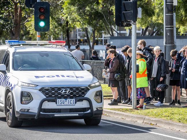 A Glen Eira College student was pulled into a grey Volkswagen on Monday as he walked home from school, he was robbed of his phone and other items and was seriously injured as he got out of the moving car. Police drive past the school along Booran Rd. Picture: Jake Nowakowski