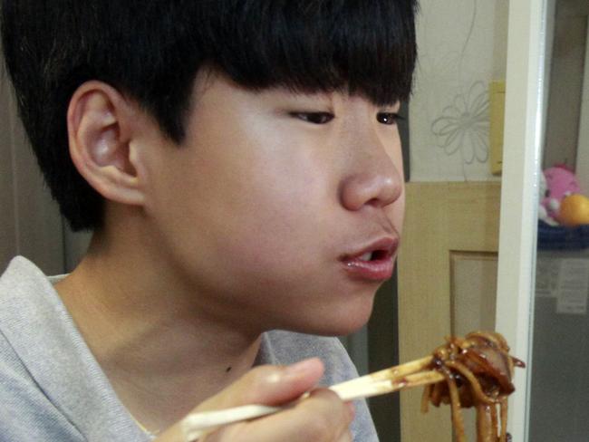 In this Monday, Aug. 17, 2015 photo, Kim Sung-jin, 14, broadcasts himself eating delivery Chinese food in his room at home in Bucheon, south of Seoul, South Korea. Every evening, he gorges on food as he chats before a live camera with hundreds, sometimes thousands, of teenagers watching. That’s the show, and it makes Kim money: 2 million won ($1,700) in his most successful episode. Better known to his viewers by the nickname Patoo, he is one of the youngest broadcasters on Afreeca TV, an app for live-broadcasting video online launched in 2006. (AP Photo/Julie Yoon)