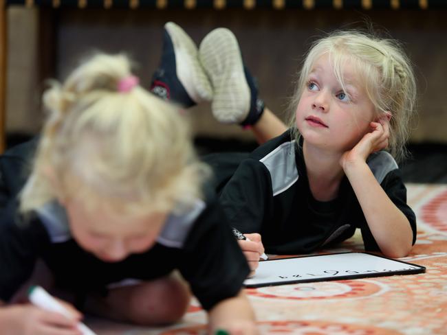 Central Coast Sports College kindy kids love writing on the whiteboards. Picture: Sue Graham