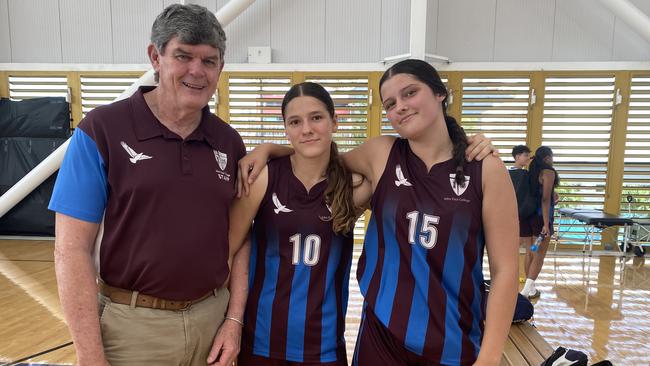 John Paul College coach Jeff Henderson with U15 Division 1 Girls players Olivia Olechnowicz, 13, and Chloe Bruton, 14.