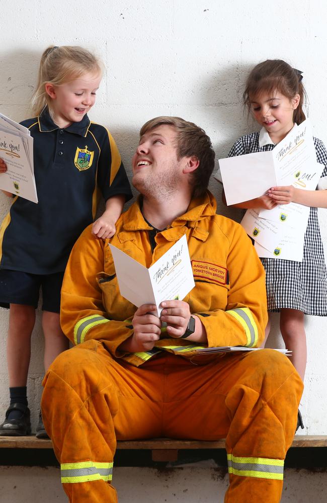 Yorketown CFS volunteer Angas McEvoy with St Columba’s Memorial School reception students Alexandra and Elle and their cards. Picture: Tait Schmaal