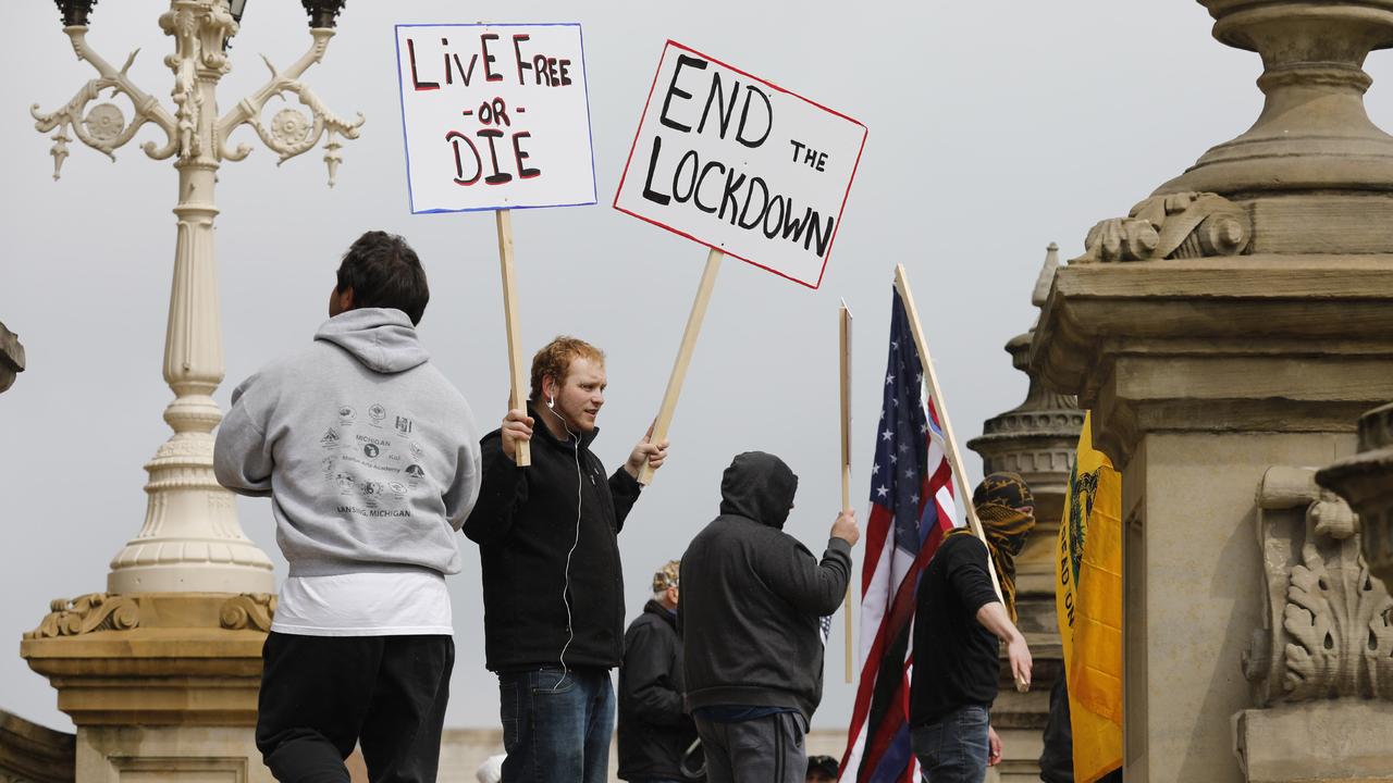 Protesters (above) at the Michigan State Capitol and in states throughout the US say they fear the lockdown and job lay-offs more than the virus. Picture: Jeff Kowalsky