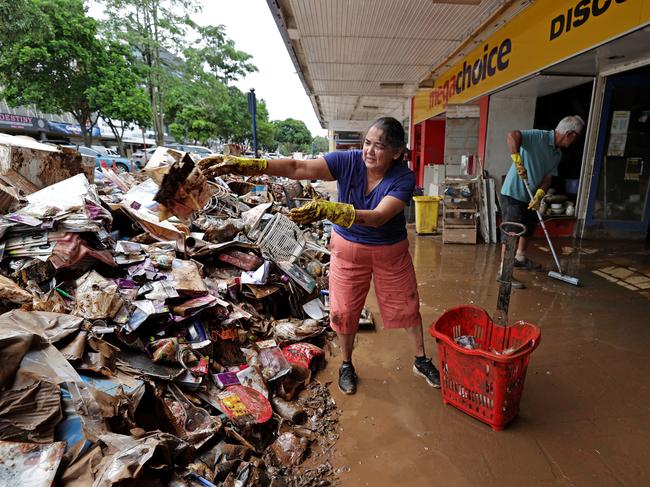 Shop owners Jaishree and Saras Solanki remove damaged stock and furniture on Molesworth St, Lismore on March 4 last year. Picture: Toby Zerna