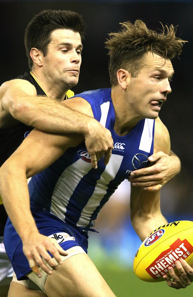 Trent Cotchin catches Shaun Higgins. Picture: Wayne Ludbey