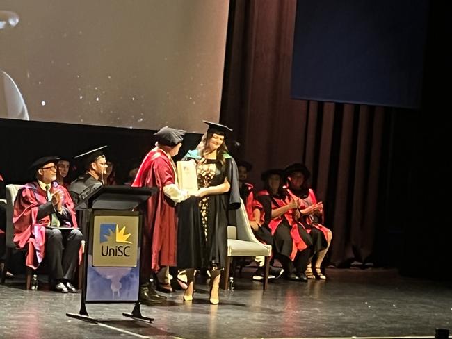 Graduates from the University of the Sunshine Coast's Fraser Coast campus celebrating at the Brolga Theatre.