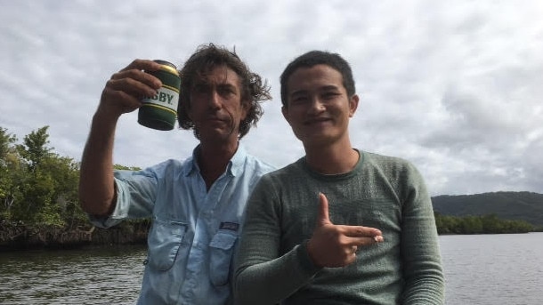 Justin Ward sharing a beer and a cigarette with a suspected asylum seeker. Picture: Supplied