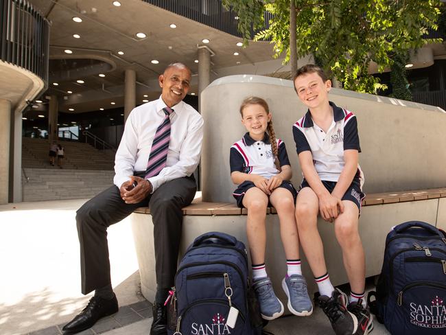 22/11/23. The Daily Telegraph. Education / News.. Gables, Sydney, NSW, Australia.Portraits of The Principle of Santa Sophia Catholic College Mark de Vries chatting to Aron (9) and Fiadh (7)  Gildernew from Box Hill, , who moved to the school 3 months ago from County Tyrone in Ireland.Santa Sophia Catholic College is the state's fastest growing school - opening formally in 2021. Part of a broader trend of families choosing private schooling over public schools.Picture: Julian Andrews