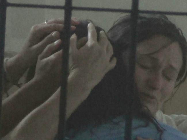 Friends comfort Sara Connor in her at Denpasar Police station cell.