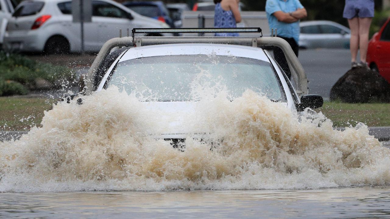 17th December 2020 - Drivers ignore Flood warnings to drive through heavy flood water after the Tallebudgera Creek burst its banks at the western end of 19th Avenue Elanora.Photo: Scott Powick Newscorp