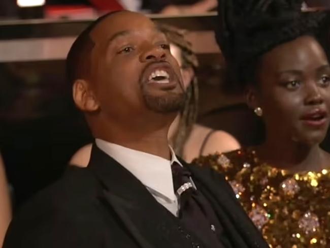 Will Smith, visibly emotional, walked back to his seat in the audience and shouted: 'Keep my wife's name out of your f***ing mouth' to Chris Rock after slapping him on stage at the 2022 oscar awards. Picture: ABC