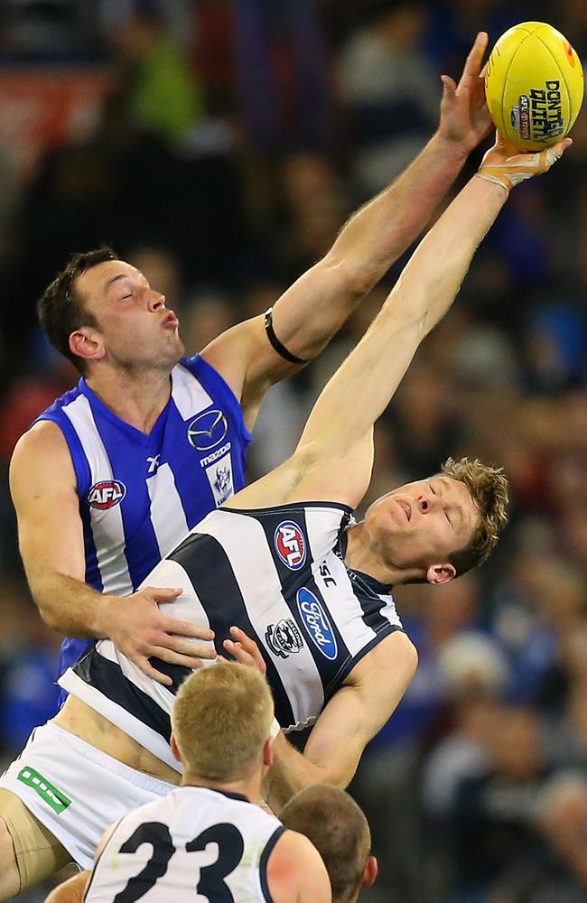 North Melbourne ruckman Todd Goldstein leaps over Geelong utility Mark Blicavs. Picture: Getty