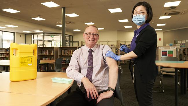 Charles Campbell College Principal, Kevin O’Neil with nurse Monica Jeong. Picture: Matt Loxton