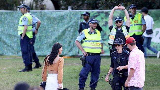 Police with sniffer dogs search people after they enter through the main entrance at the Listen Out Music Festival, Centennial Park, Sydney. 5th October 2019. Picture by Damian Shaw