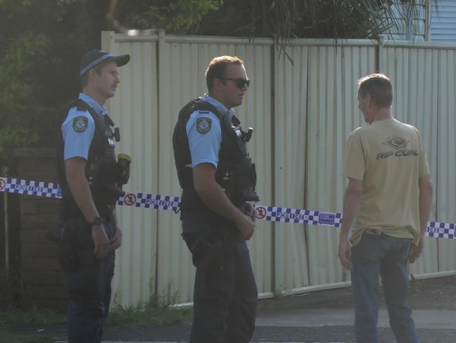 Police out the front of a home in Woy Woy speaking to a neighbour. Picture: Satria Dyer-Darmawan