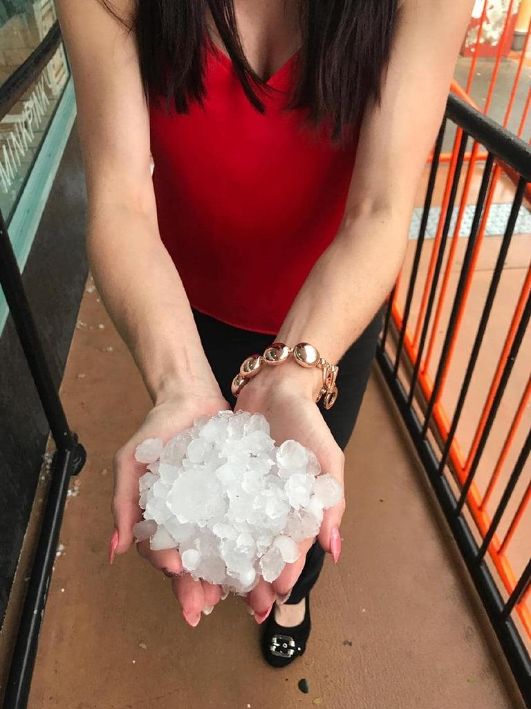 A Gympie resident with handfuls of hail.