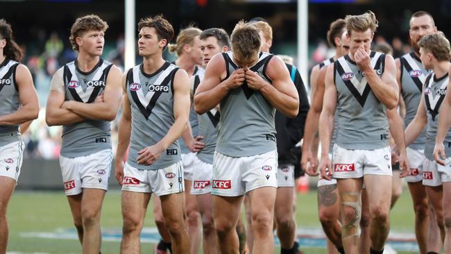 The Power walk off the MCG after Saturday’s loss. Picture: Michael Willson/AFL Photos