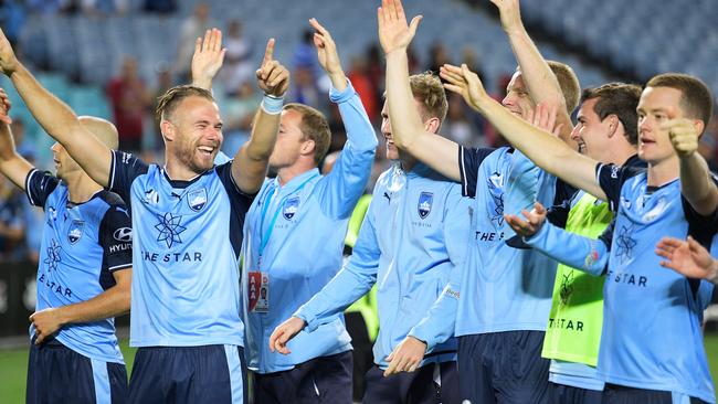 Sydney FC players celebrate their big win over Western Sydney Wanderers on Saturday night.