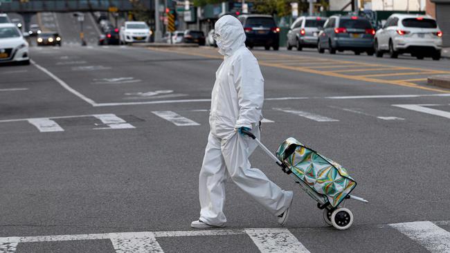 A woman heads out for grocery shopping in Queens, a borough of New York City, in April. Picture: AFP