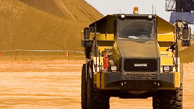 Fortescue Metals Group's iron ore stockpile is transferred onto a conveyor belt for loading into an iron ore carrier, in Port Hedland (Ron D'Raine/Bloomberg News)