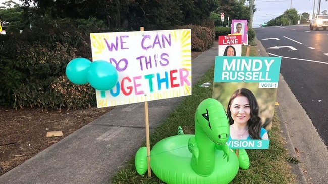 Some of the signs and a blow-up dinosaur outside a booth at Daisy Hill.