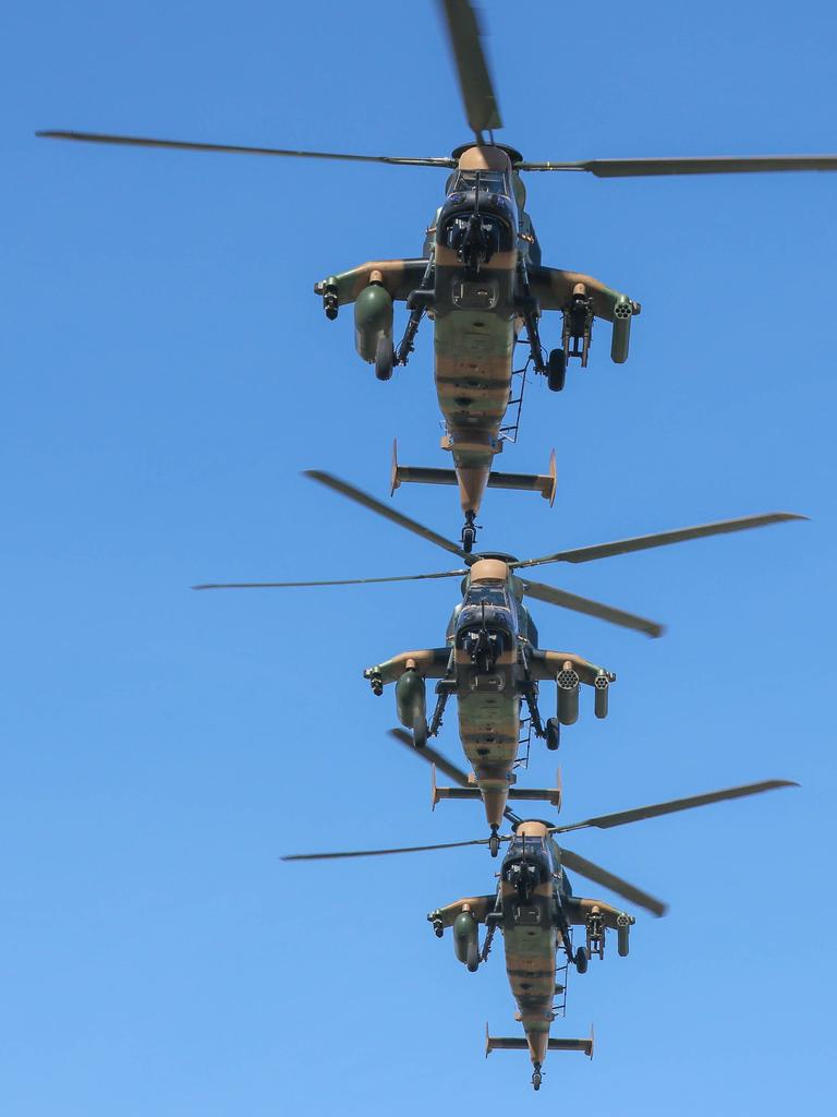 Attack Helicopters conduct a flypast during the march on Darwin's Knuckey St commemorating ANZAC Day 2021. Picture Glenn Campbell