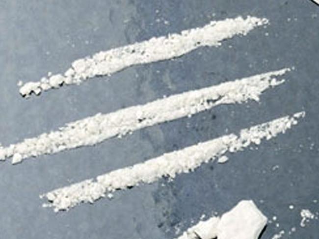 Lines of cocaine coke narcotic drug with straw and razor.