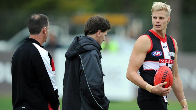 Ross Lyon chats with skipper Nick Riewoldt during his last stint at the club.