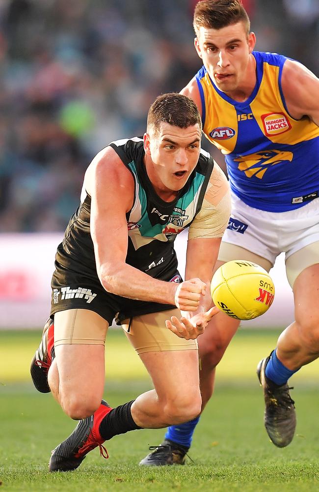 Port Adelaide’s Tom Rockliff handballs during the round 21 match against West Coast. Picture: Daniel Kalisz/Getty Images