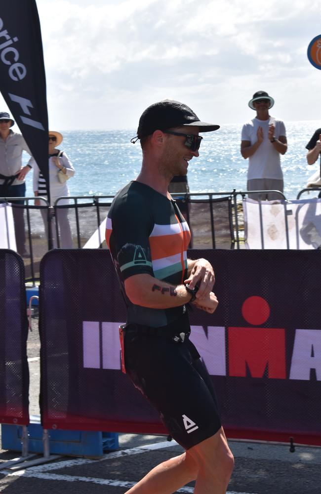 Athletes crossing the finish line at the Sunshine Coast Ironman 70.3 2023.