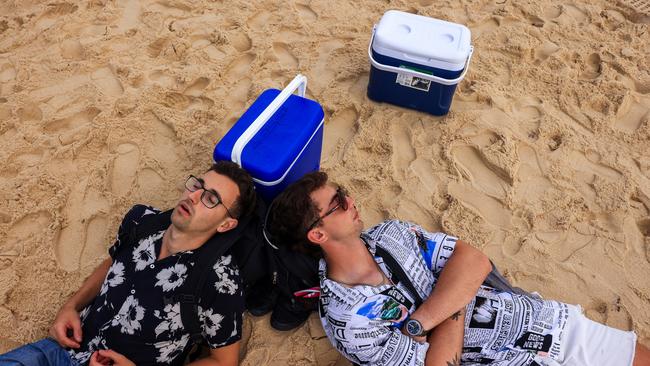 Argentinian tourists sleep by their eskies as the sun rises at Bondi beach on January 01, 2024. Picture: Jenny Evans/Getty Images