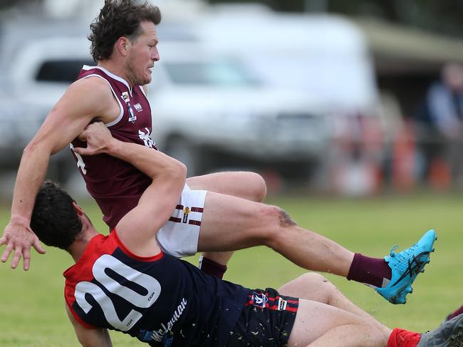 Wycheproof-Narraport’s Chris Cox brings down Nullawil’s David Isbistar in a tackle.