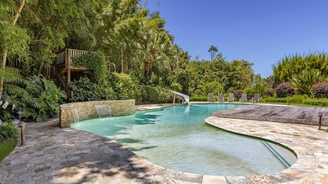 Water slide among the trees into the pool.