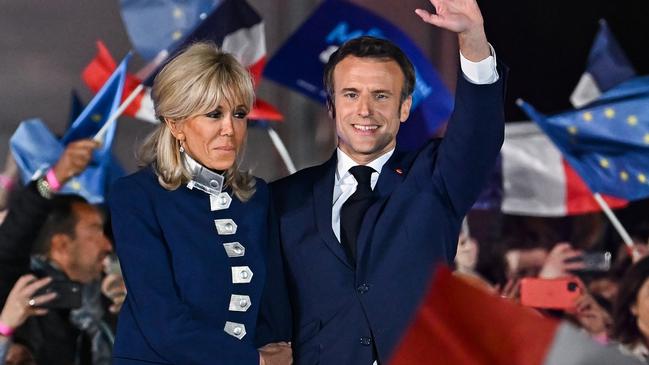 Emmanuel Macron stands with his wife Brigitte Macron after he beat his far-right rival Marine Le Pen for a second five-year term in April this year.