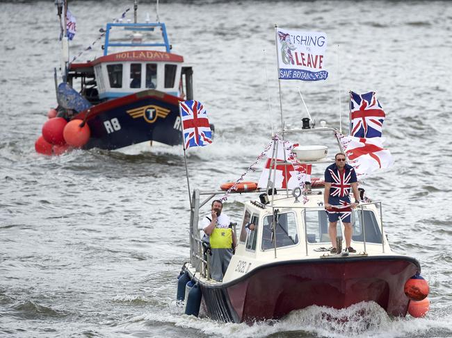 Brexit fishing boats, part of a flotilla sail up the river Thames in central London on June 15, 2016. A Brexit flotilla of fishing boats sailed up the River Thames into London today with foghorns sounding, in a protest against EU fishing quotas by the campaign for Britain to leave the European Union. / AFP PHOTO / NIKLAS HALLE'N