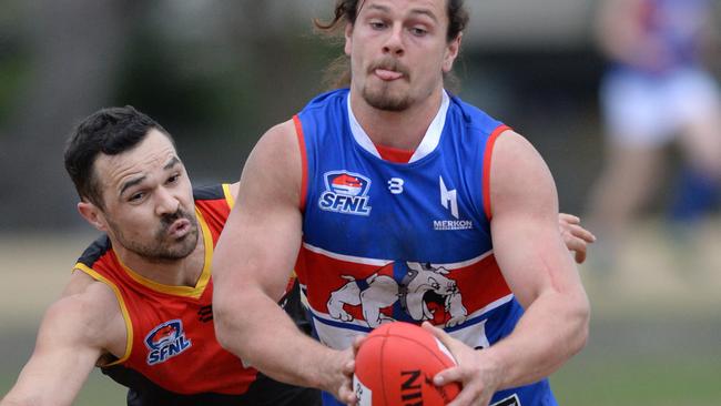 Dingley’s Jack Ades tackles St Pauls Matthew Kreymborg. Picture: Chris Eastman