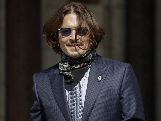 Johnny Depp smiles for the cameras as he arrives at the Royal Courts of Justice, the Strand in London. Picture: Getty Images