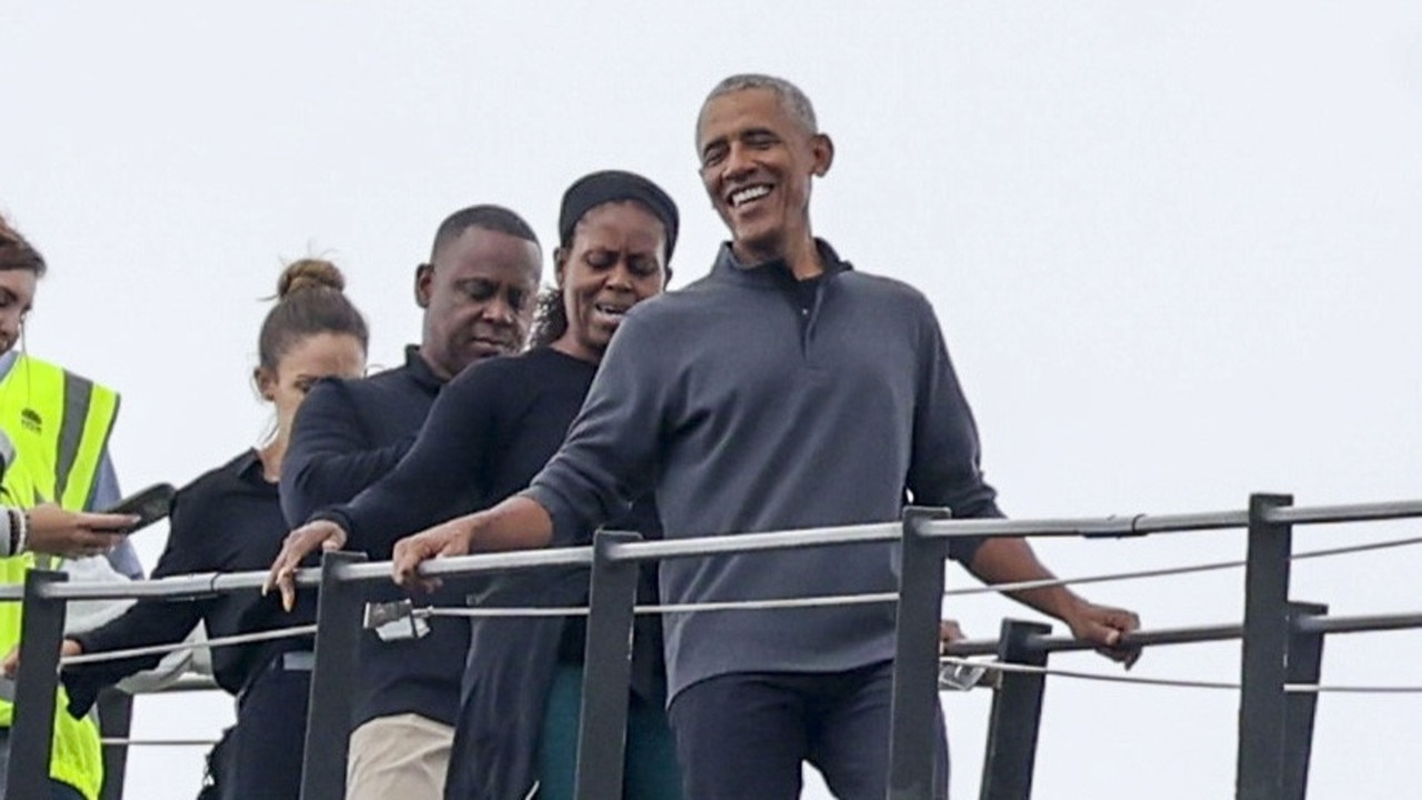 Barack and Michelle Obama climbing the harbour bridge.