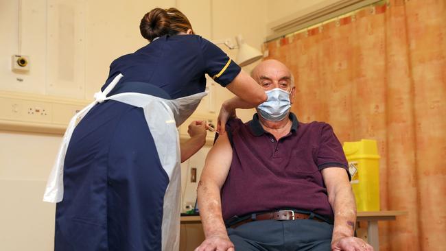 82-year-old Brian Pinker receives the Oxford University/AstraZeneca COVID-19 vaccine from nurse Sam Foster at the Churchill Hospital in Oxford on Monday. Picture: Getty Images