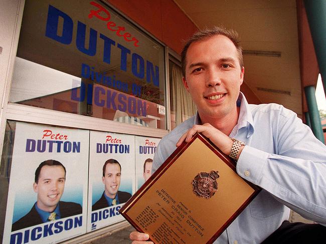 Holding his police record while running for Dickson in 2001.